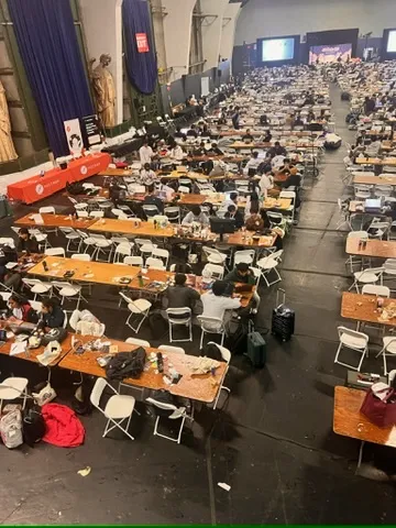 Hackathon venue with rows of tables and chairs